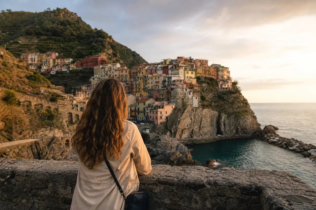 Traveler above a Mediterranean cliffside village