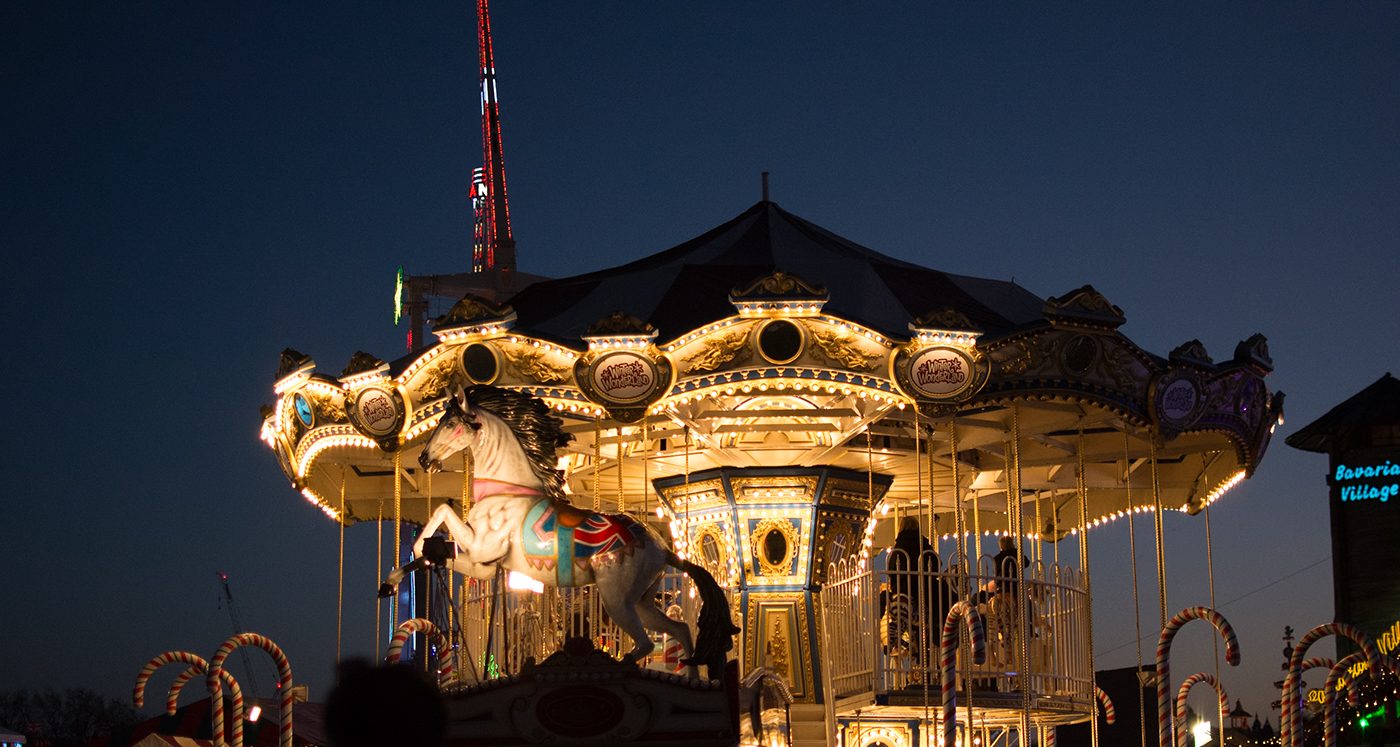 Golden carousel lit up at night, before the preset